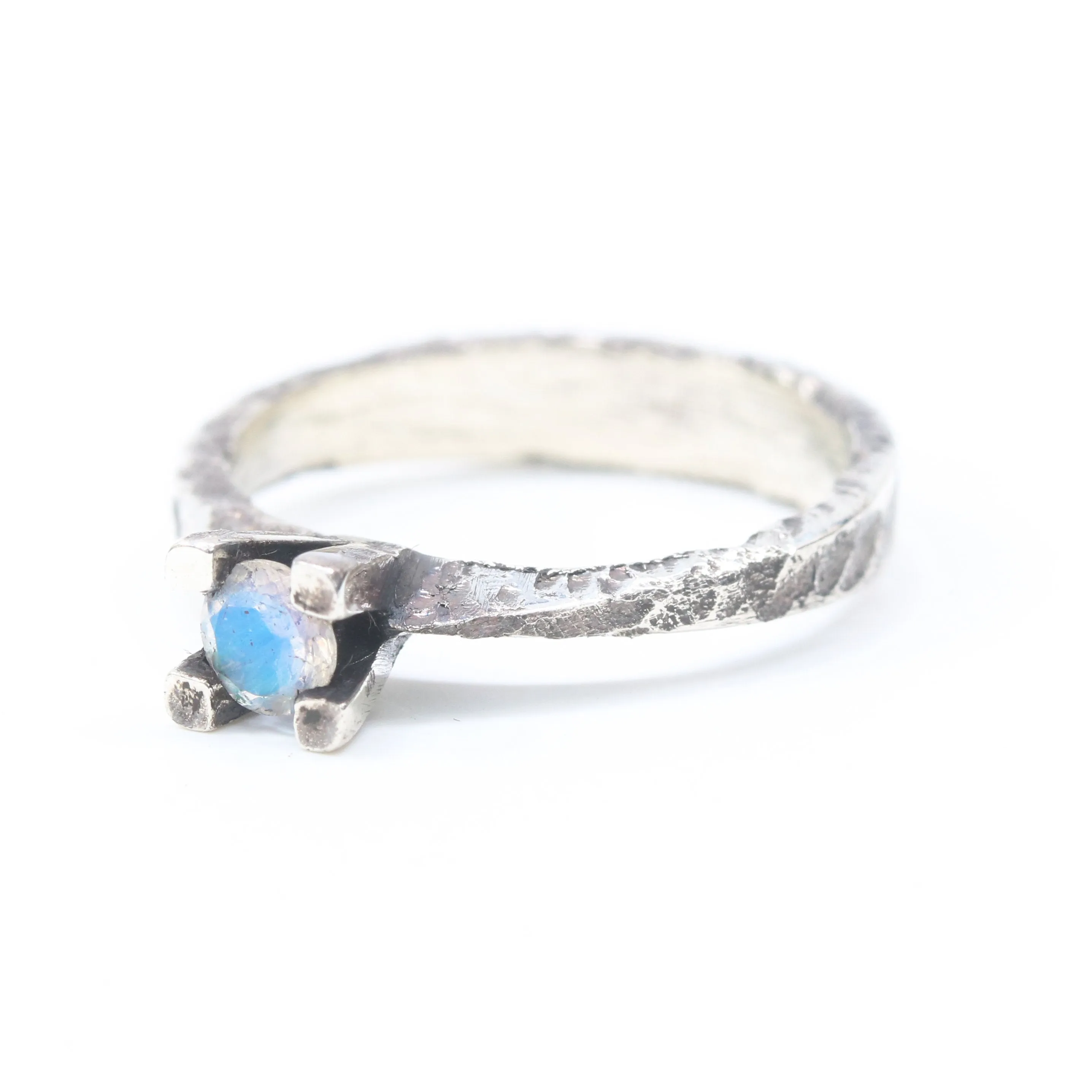 Tiny round faceted moonstone ring in silver prongs setting with sterling silver hard texture oxidized band